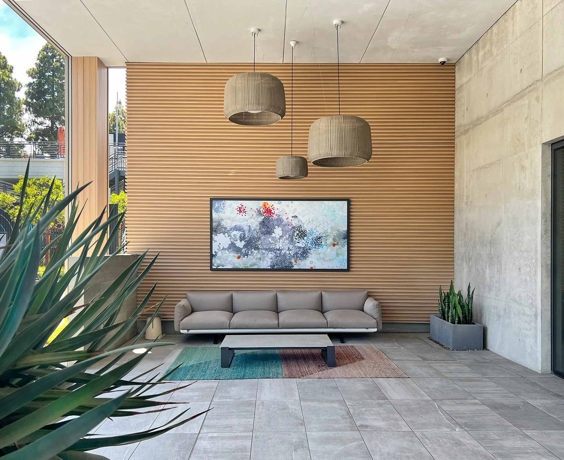 A Gensler-designed interior with an abstract painting by Heather Patterson above a lounge sofa — a Susan Street Fine Art project.
